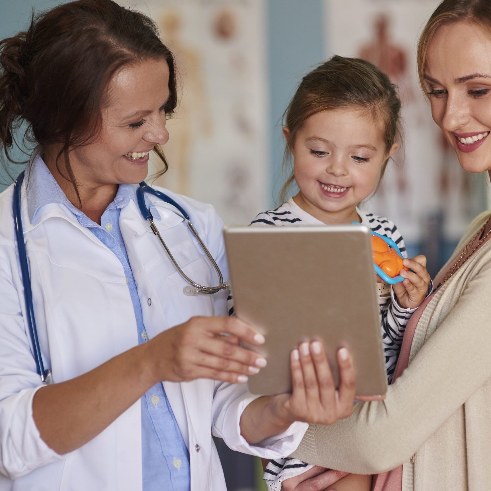 Cute toddler with her mother at the doctor
